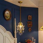Gold cage pendant light with crystal drops and ornate hanging scroll details