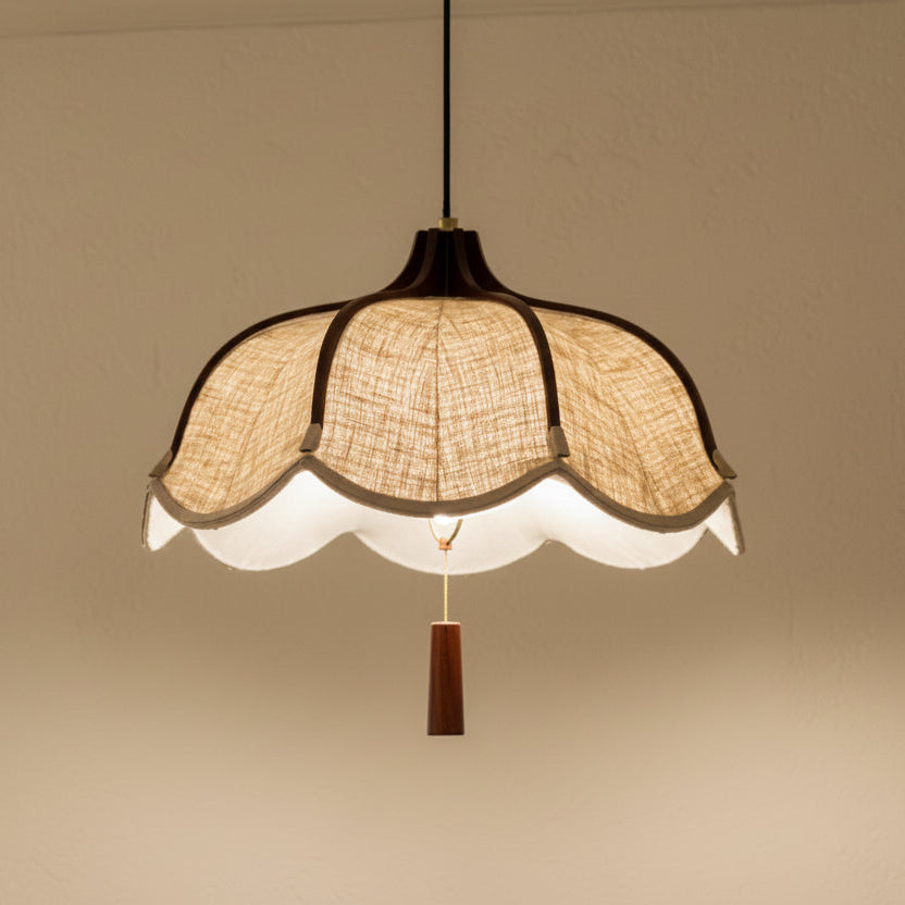 Beige scalloped fabric pendant light with warm diffuser and brown hanging finial