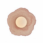 Coral pink floral disc wall light sconce with round glowing bulb and textured glass petals