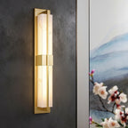 Gold vertical wall light sconce with frosted glass strip panels in a long frame