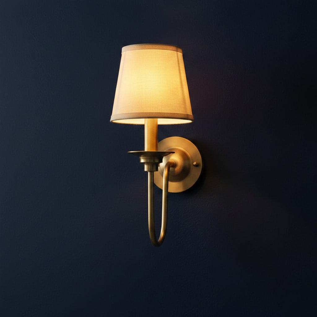 Brass single-arm wall sconce with conical drum shade and curved gooseneck arm