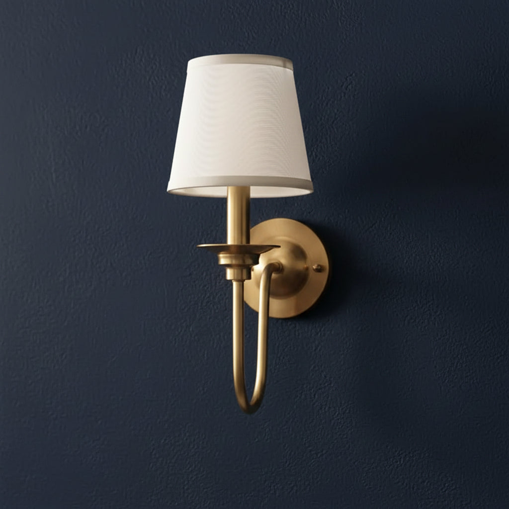 Gold-tone single-arm wall sconce with white conical shade and curved gooseneck arm