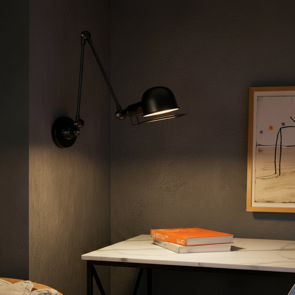 Black hinged swing-arm dome wall light, angled head with glowing bulb