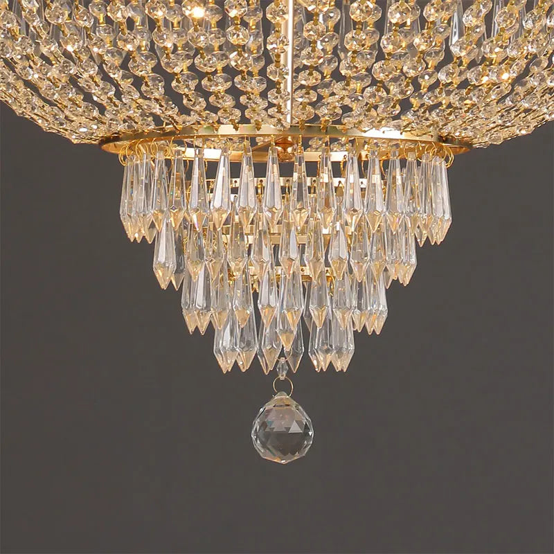 Gold crystal chandelier with long teardrop chains and faceted crystal hanging drop