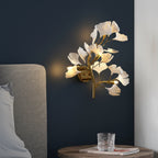 Gold ginkgo leaf wall sconce with glowing white acrylic petals, wall mounted
