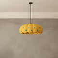 Yellow pumpkin-style pendant light with scalloped shade and blue dot pattern