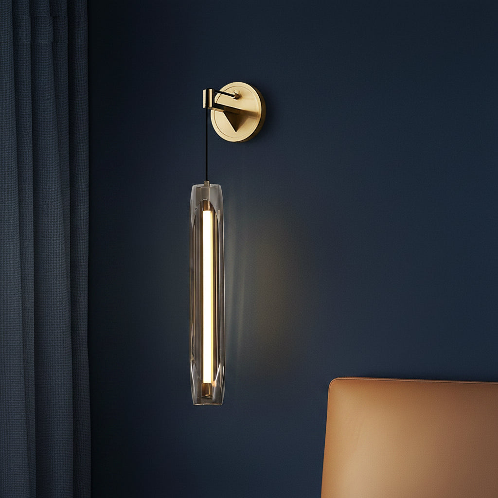 Brass tubular glass wall light with cylindrical clear glass shade and slim black cord