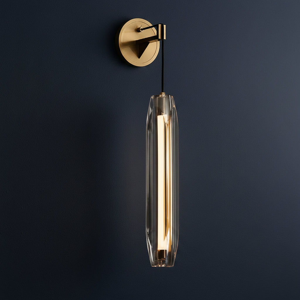Minimal brass wall light with clear glass cylinder and dark cable