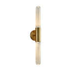 Framed wall light on white background: clear fluted glass tube with brass circular mount.