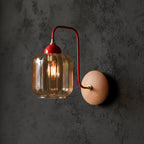 Red curved arm wall light with ribbed cylindrical glass shade and round wood backplate, lit