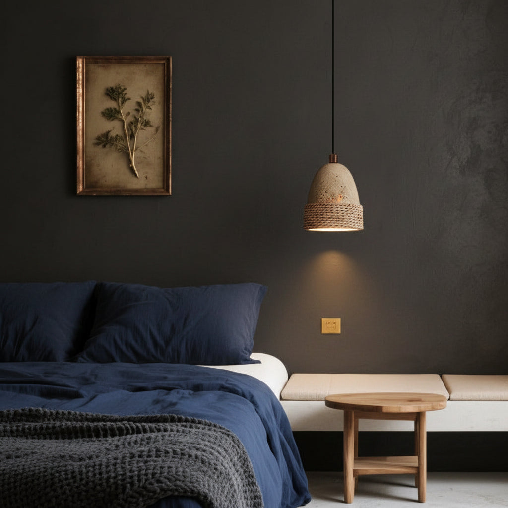 Elri bell pendant light with travertine shade and woven rope band, hanging above bed