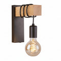 Industrial wall sconce featuring dark metal backplate, light wood mount, and clear globe bulb