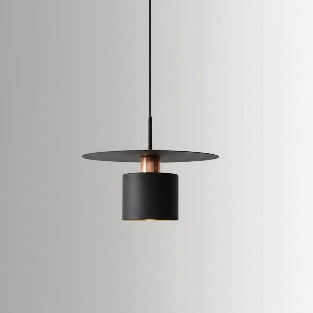 Single black cylindrical pendant light with a warm glowing bulb