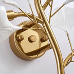 Close-up of gold ginkgo leaf wall sconce base and acrylic petal arms