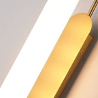 Gold-toned metal arm with warm amber cylindrical opal diffuser for wall light