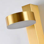 Gold cylindrical wall sconce shade with angled head detail for vertical mounting