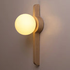 Wall globe sconce with opal globe and light wood vertical arm with natural grain