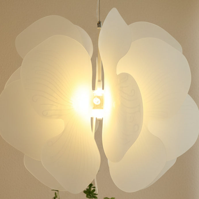 Close-up floral acrylic pendant light with layered petals and illuminated bulb