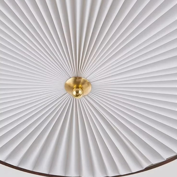 White pleated UFO-style lamp shade with gold bulb holder