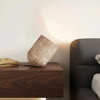 Travertine cylindrical table lamp, slanted beige stone base with braided cord