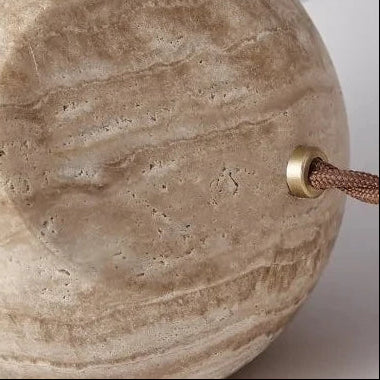 Textured beige travertine lamp with metal socket and braided cord