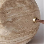 Textured beige travertine lamp with metal socket and braided cord