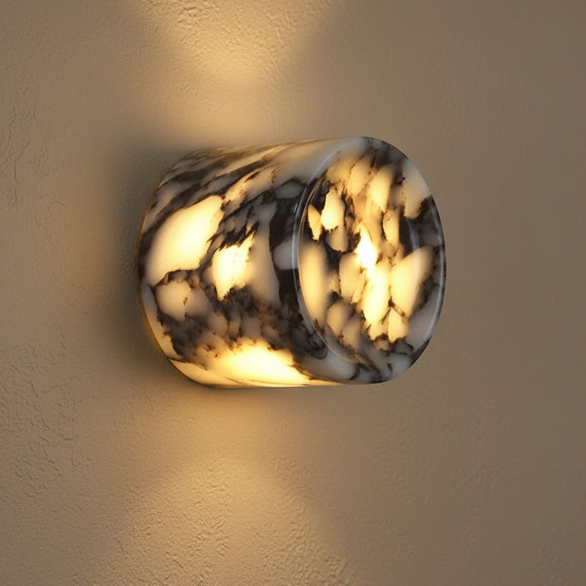Marble cylinder wall light, warm glow through round stone-pattern shade