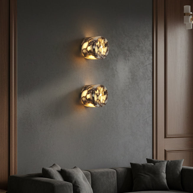 Set of two marble cylinder wall lights with round shades on dark wall