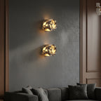 Set of two marble cylinder wall lights with round shades on dark wall