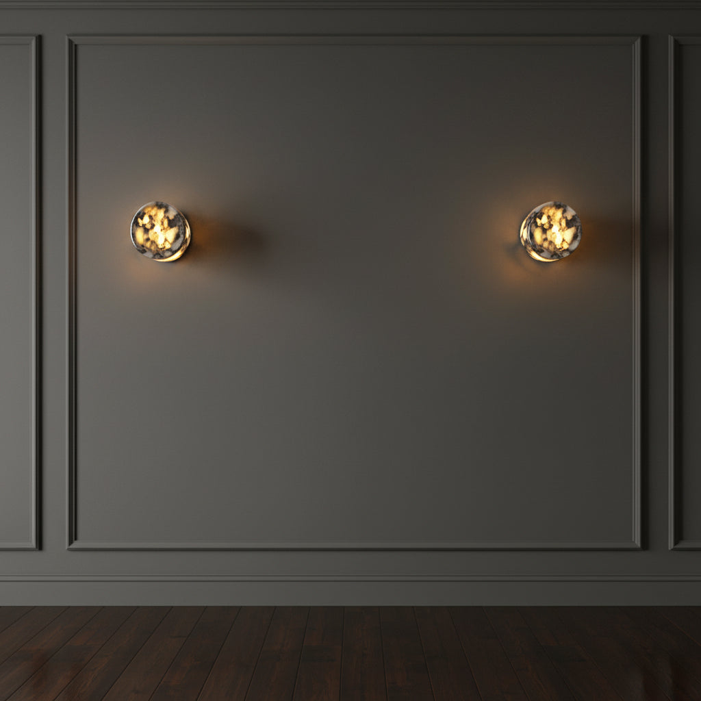 Two marble cylinder wall lights on panelled wall with warm light