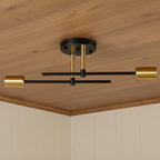 Two-light flush mount ceiling fixture with round black canopy and two gold shade ends