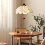 Layered fabric petal pendant light with cream shade and brown hanging finial