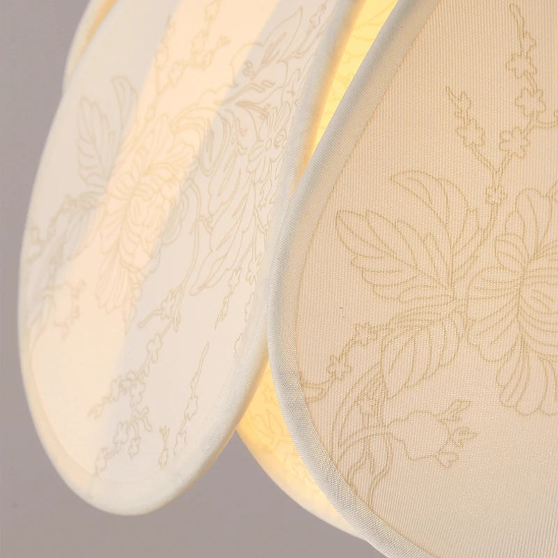 Close-up fabric petal shade in cream with subtle floral pattern texture
