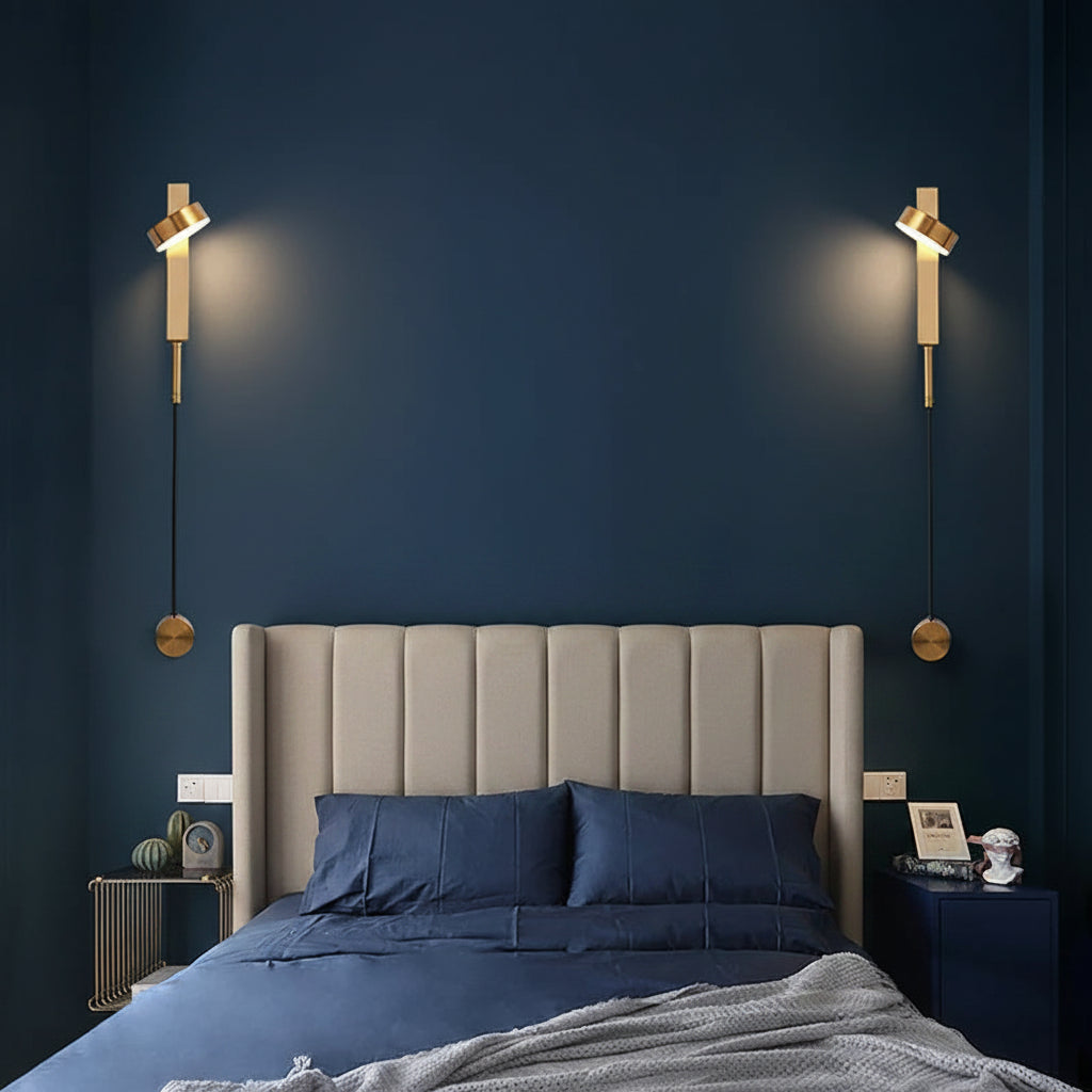 Pair of gold vertical wall sconces with cylindrical shades and pull-switch knobs, wall-mounted
