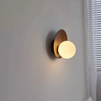 Log wood wall sconce with opal globe glass shade and round curved backplate