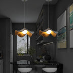 Curved wooden pendant light with warm glowing bulb in a modern hallway
