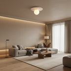 Round flush mount ceiling light with frosted globe and travertine-textured disk