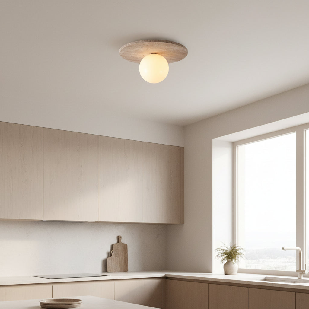 Round travertine-textured flush mount ceiling light with glowing globe shade