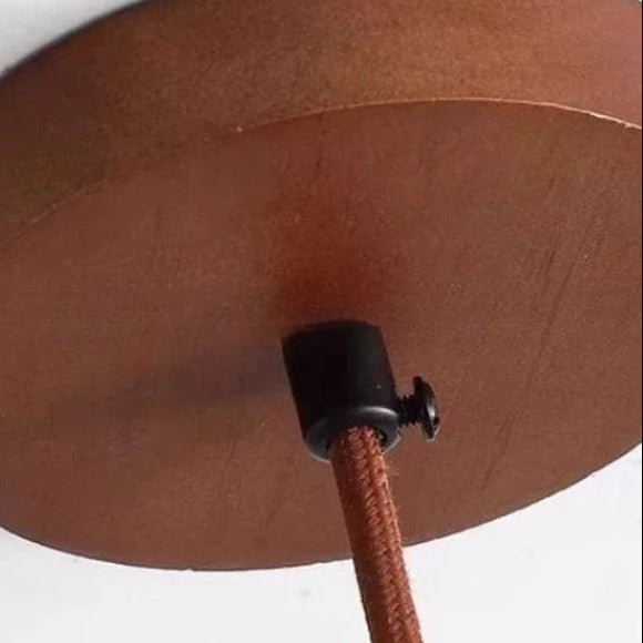 Travertine pendant underside with wood cord connector and hanging stem