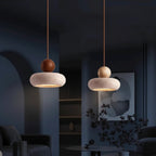 Travertine stacked pendant light with round wood top and curved stone shade