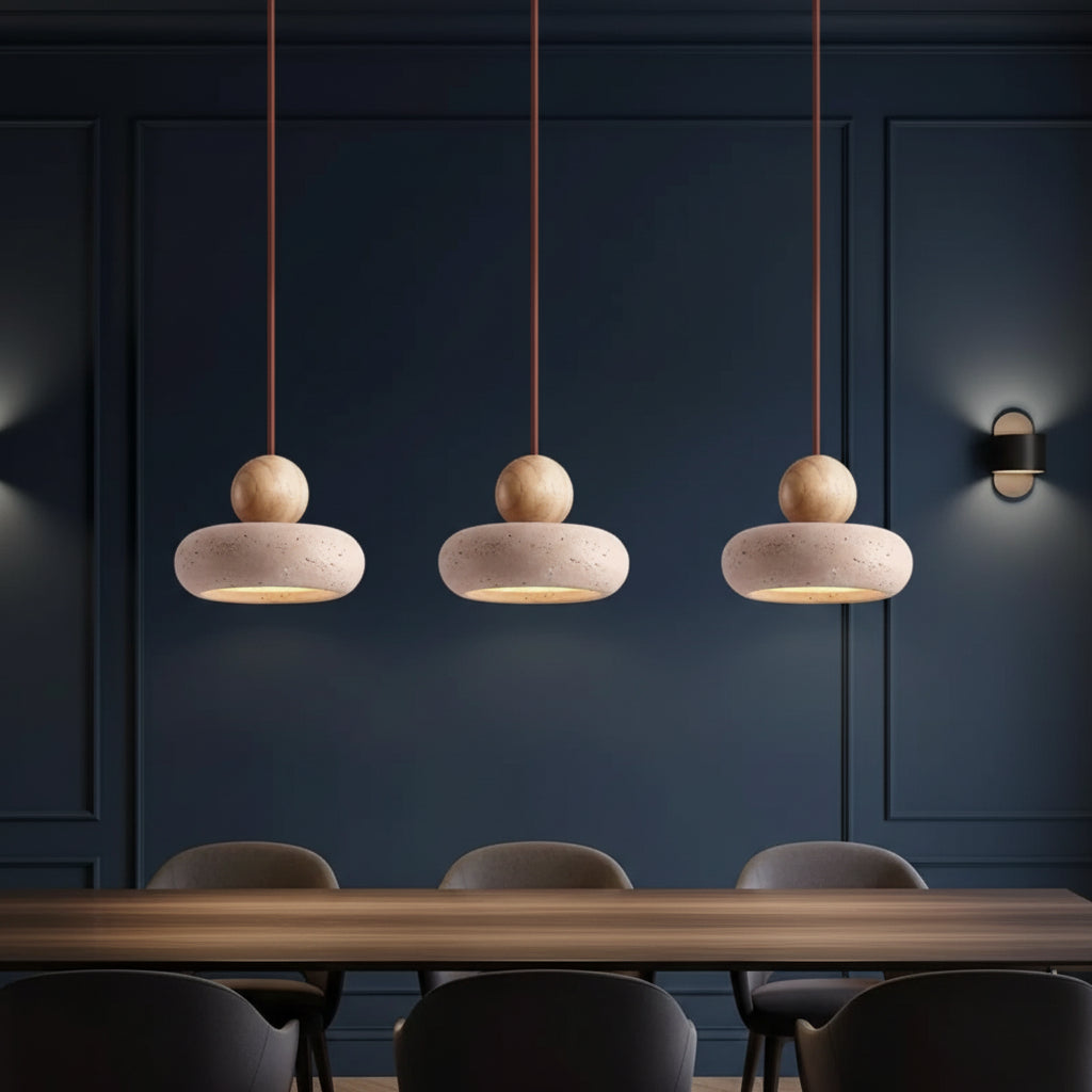 Three stacked pendant lights with travertine shades and wood spheres on cords