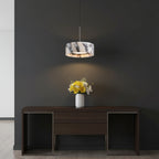 Marble drum pendant light with white marble shade and warm inner glow