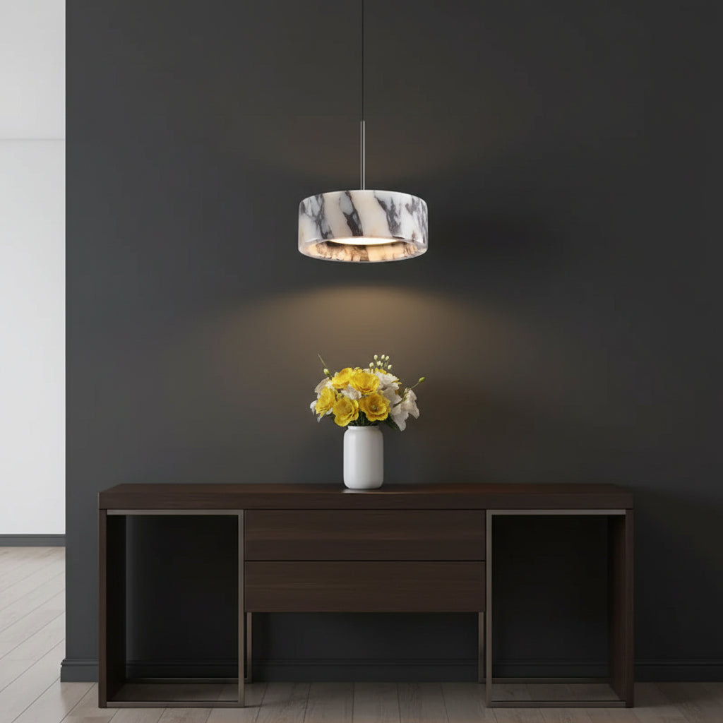 Marble drum pendant light with white marble shade and warm inner glow