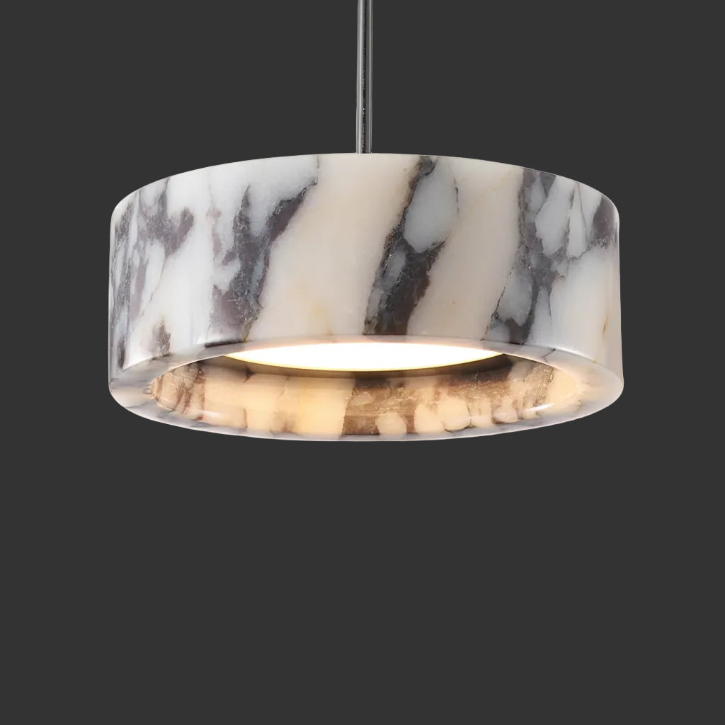 White and gray marble drum pendant light with lit interior and black rod