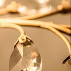 Hanging clear crystal prism on black metal branch chandelier