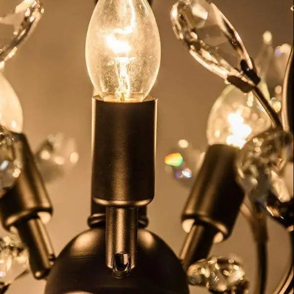 Clear glass bulb and black metal socket with warm glow on crystal chandelier
