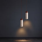 Pair of travertine cylinder pendant lights with speckled shades and dark brown caps