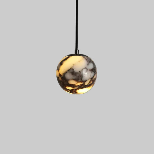 Marble glass orb pendant light with black cord and polished metal top