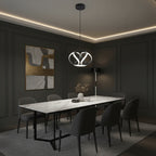 Twisted ribbon pendant light above dining table, silver ring with black inner loops