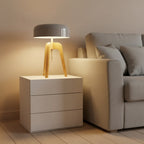 Tripod table lamp with dark dome shade and light wood tripod legs